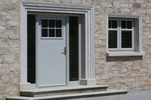 Citywest Village Development by Davy Hackey Glide Dublin 24, Showhouse Nr.11. Mourne door view from inside to outside. Door sash inside white, outside in blue with handle and letterbox in silver satin and two sidelights and toplight with maynooth glass.